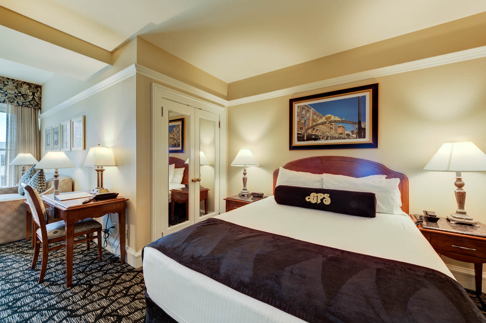 A charming master bedroom and living room area at VRI's Gaslamp Plaza Suites in San Diego, California.
